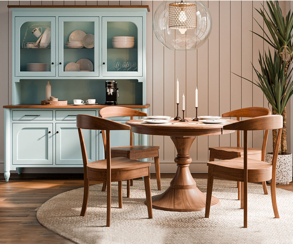 Dining room with a solid wood round table and chairs, set against a modern hutch with soft pastel tones.