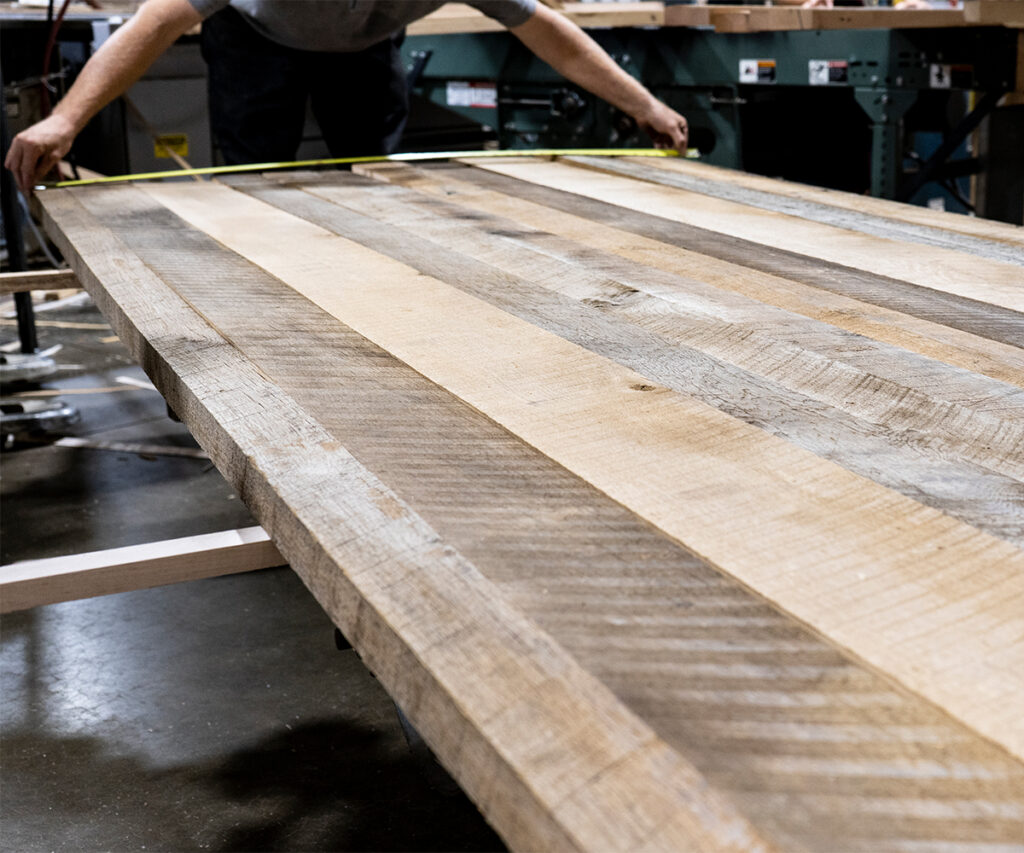 Amish working with a wood glue-up slab