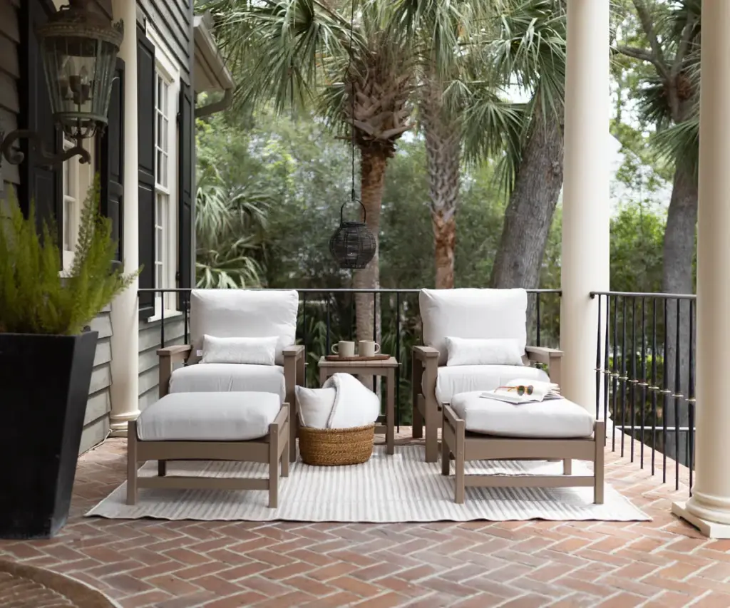 Poly furniture lounge chairs on a covered porch with outdoor cushions