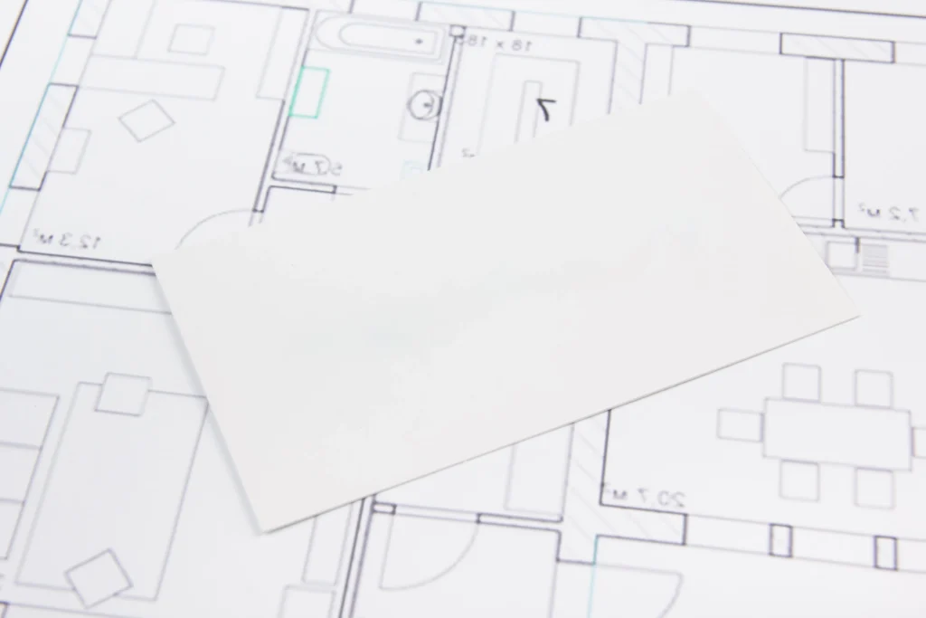 Architectural floor plan with a blank white card placed over a dining room layout.