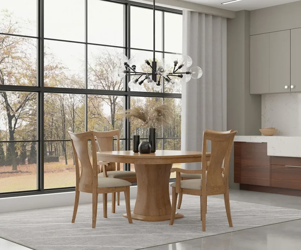 Round wood pedestal dining table with four upholstered chairs in a modern dining room.